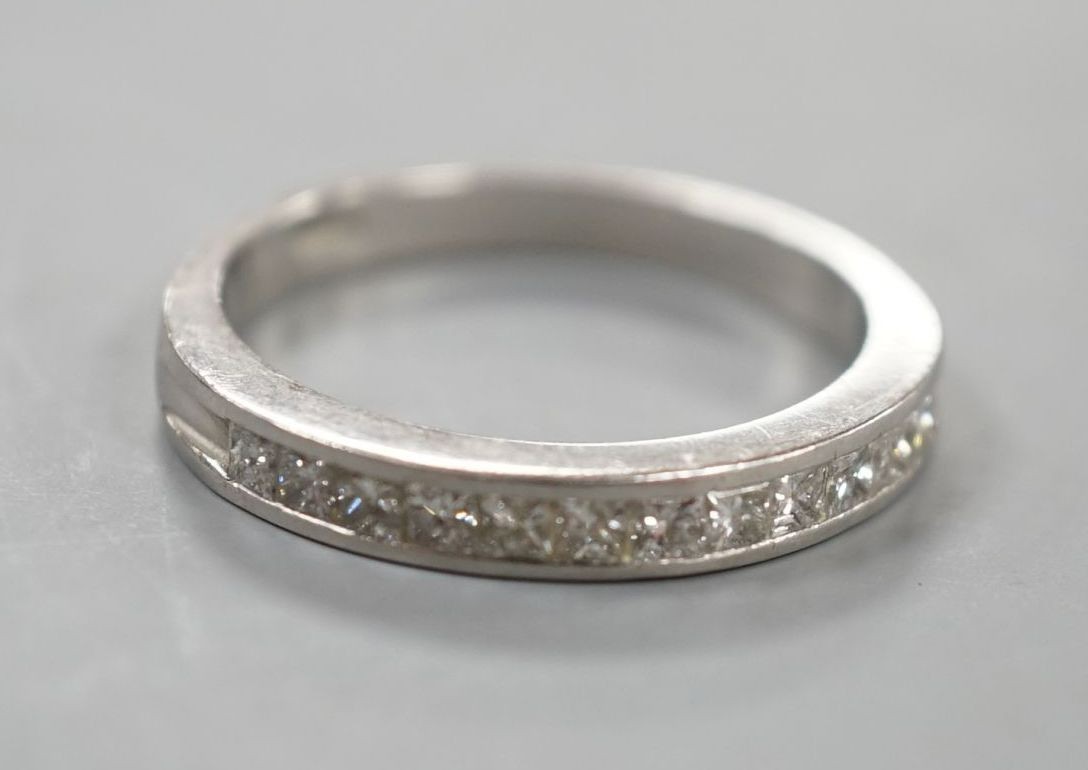 A platinum and twelve stone diamond set half eternity ring, size R, gross weight 6.4 grams.